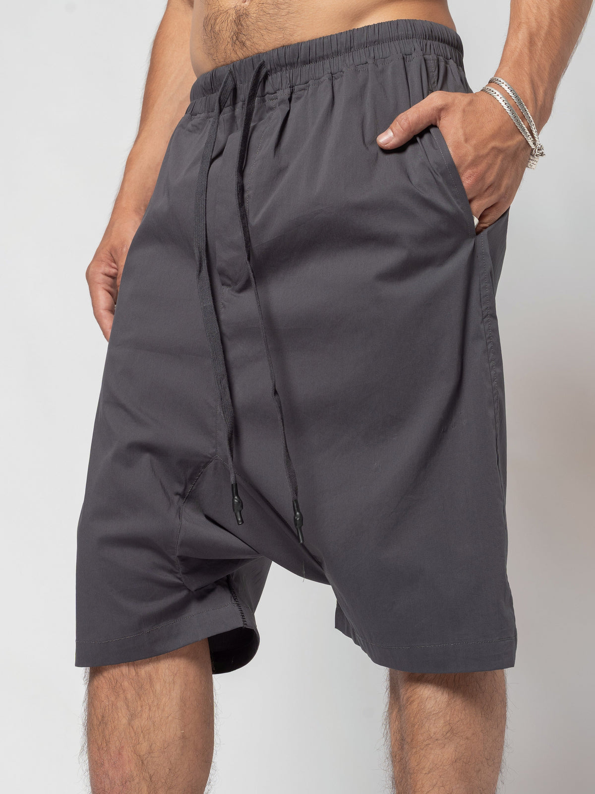 AITO Drop-Crotch Cotton Shorts in Dark Grey - hip and thigh crop with the drawcord hanging loose over the dropped crotch