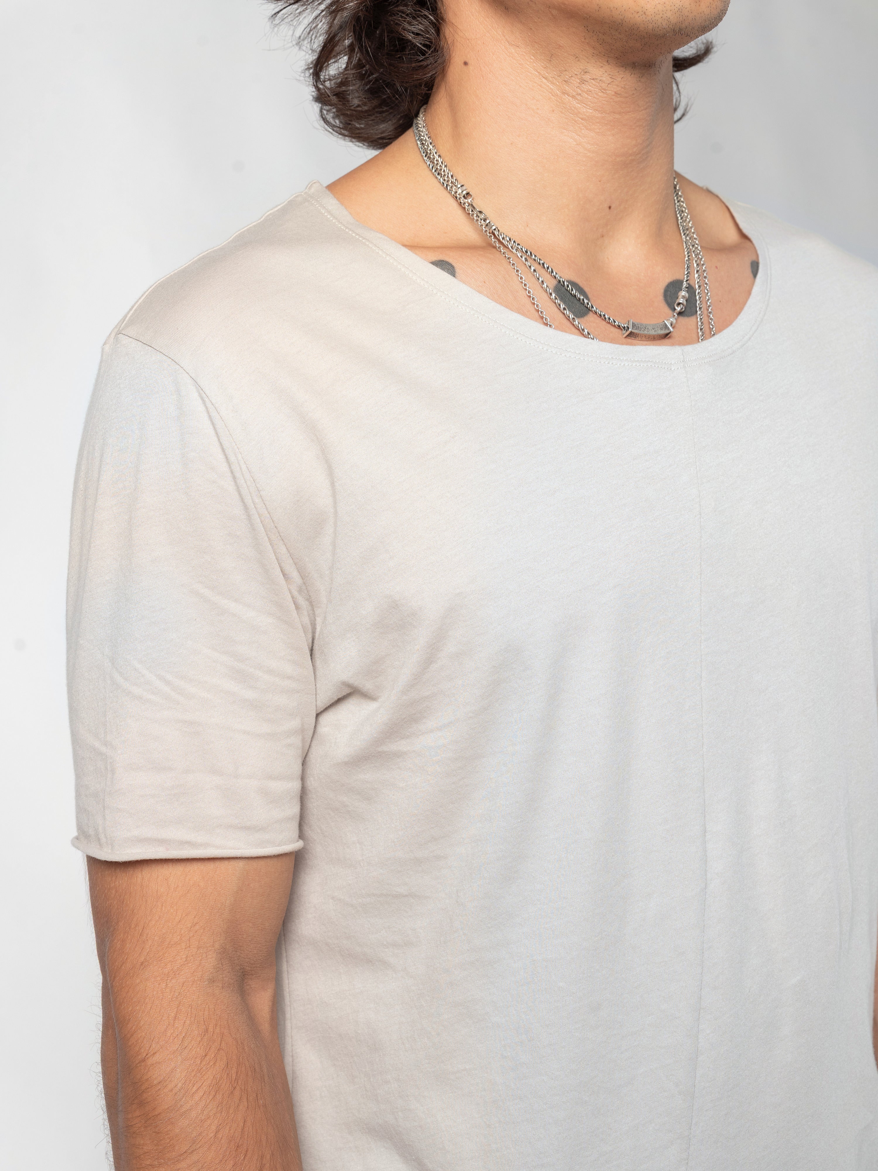 AITO Scoop Neck Cotton T-Shirt in Off White - close-up of one shoulder and the wide neckline, the model turned slightly away