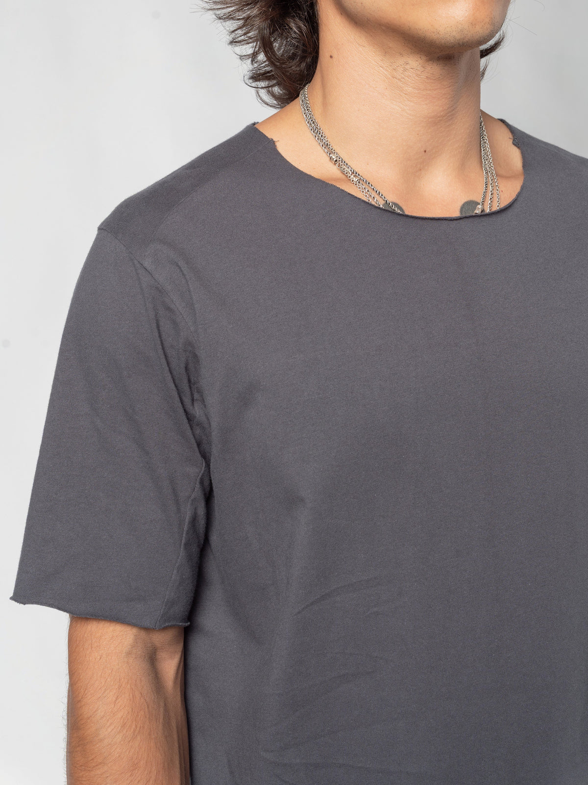AITO Scar Stitch Cotton T-Shirt in Charcoal - close-up of the round neckline and the right shoulder, the seam running out over the shoulder