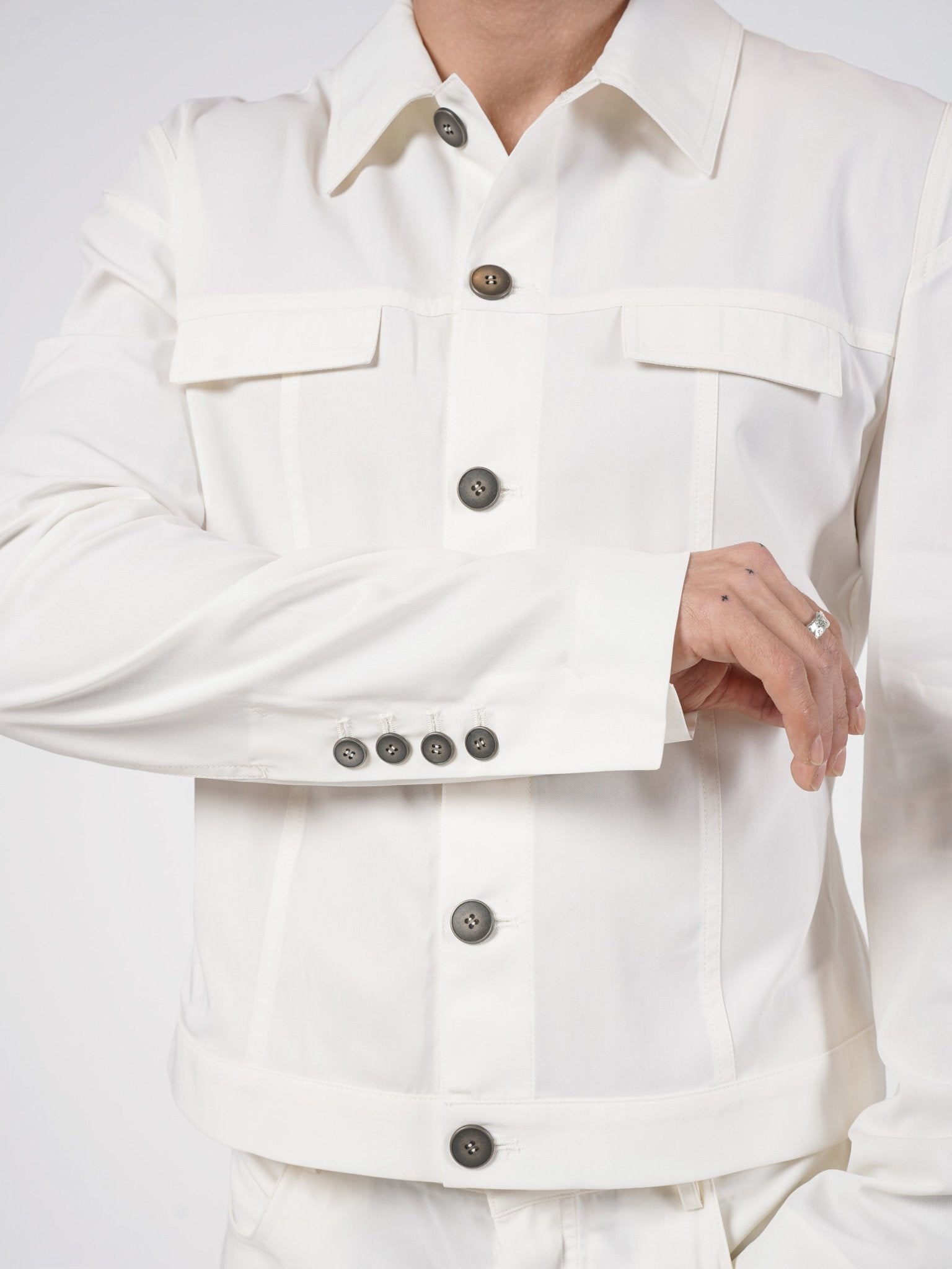 SAPIO cropped cotton jacket front detail - five-button placket, flap pockets, extended cuff