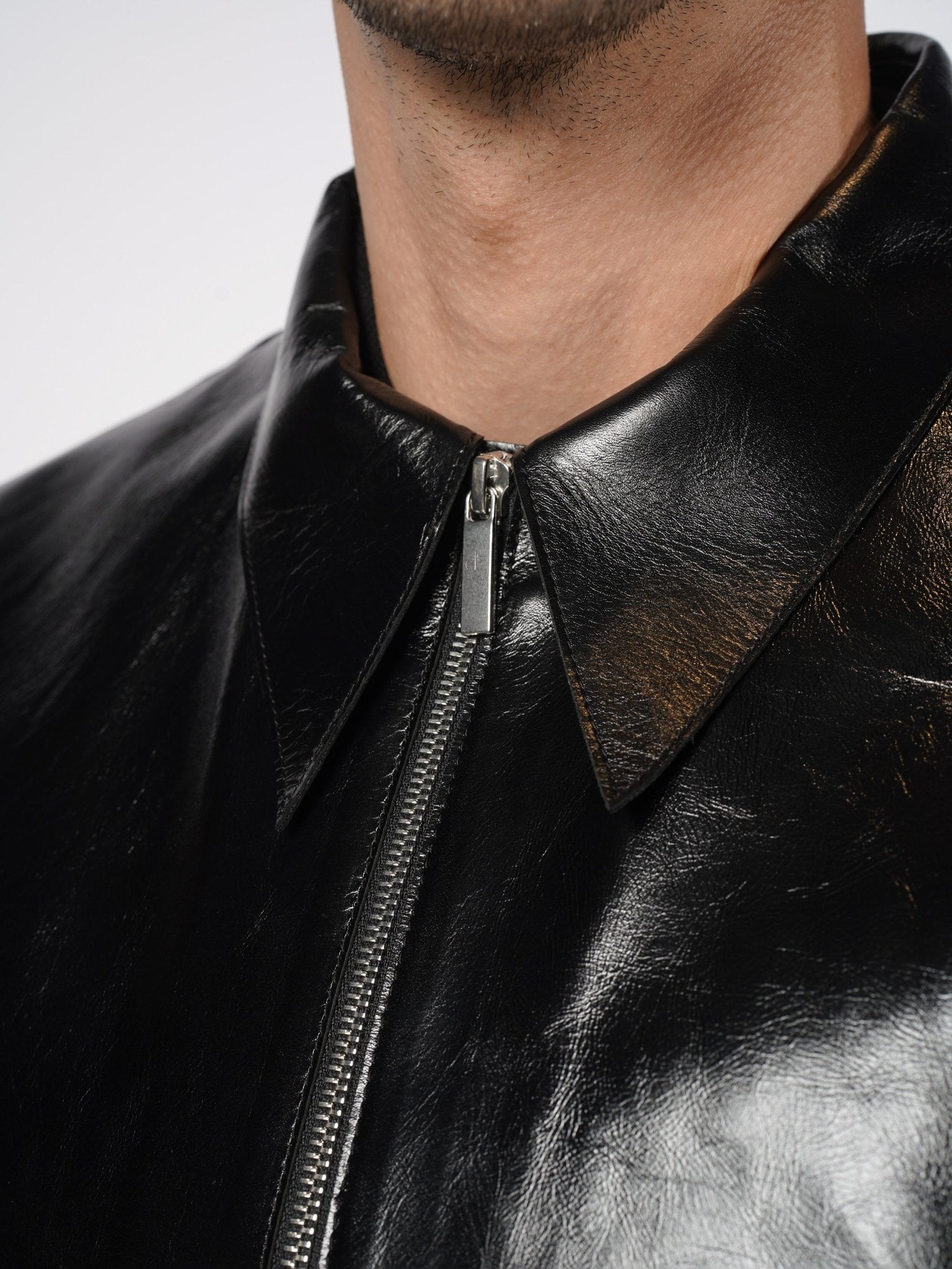 SAPIO black leather point collar and centre-front zip close-up, SS26