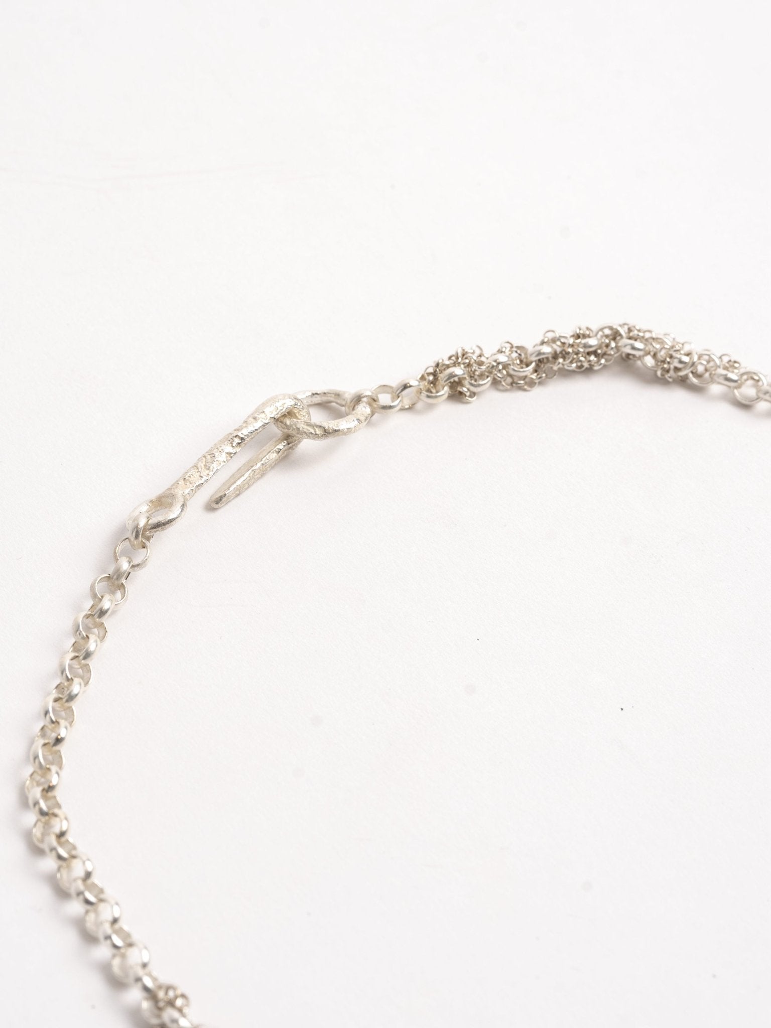 MAYA NOACH Mixed-Chain Necklace clasp detail - hand-shaped sterling silver hook with raw textured finish
